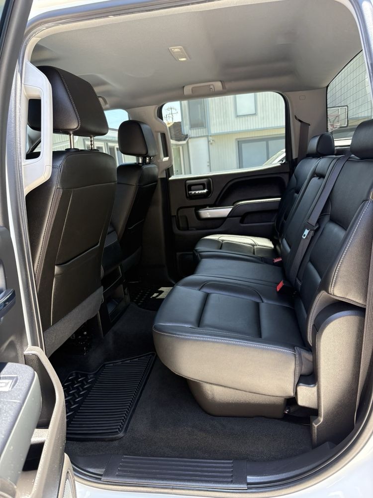 Rear leather bench seat and floor mats in a pickup truck cab